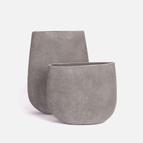 Two gray concrete planters on a white background