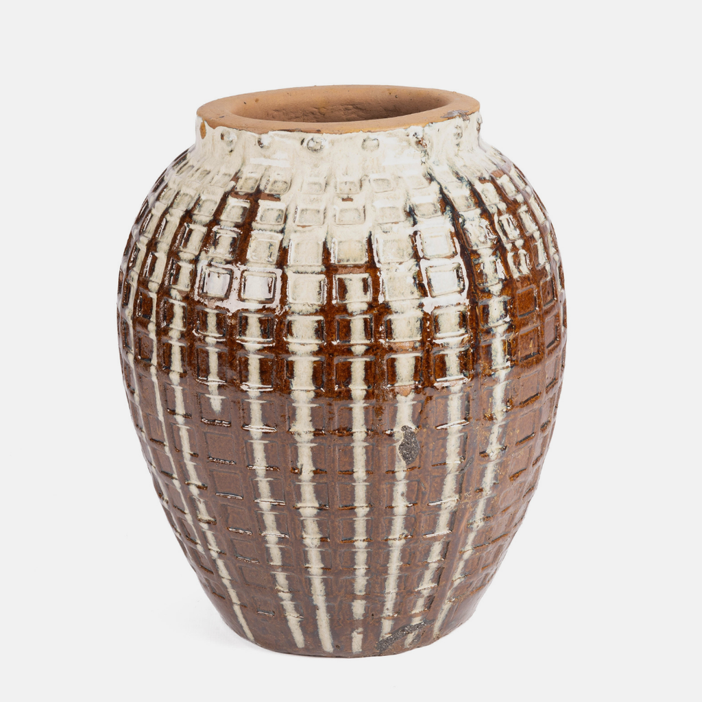 A handmade ceramic vase with a textured, basket-weave pattern in brown and cream glaze, shown against a plain light gray background.