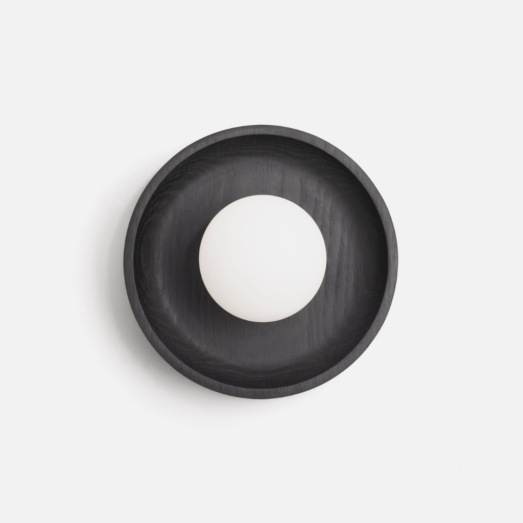 Black Oak Wall Sconce with frosted white bulb in the centre