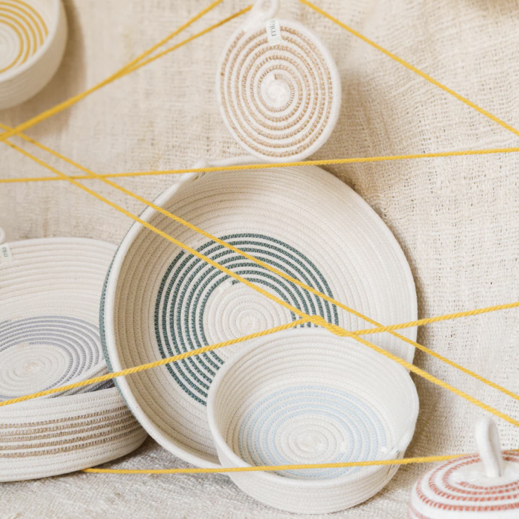 Woven baskets with circular patterns on a textured surface
