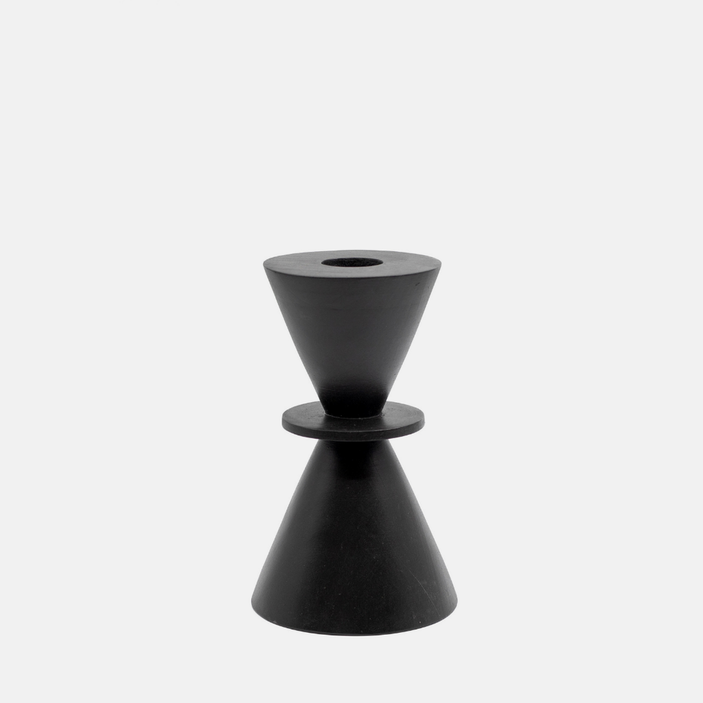 A minimalist black geometric candle holder with a dual-cone design, set against a solid light gray background.