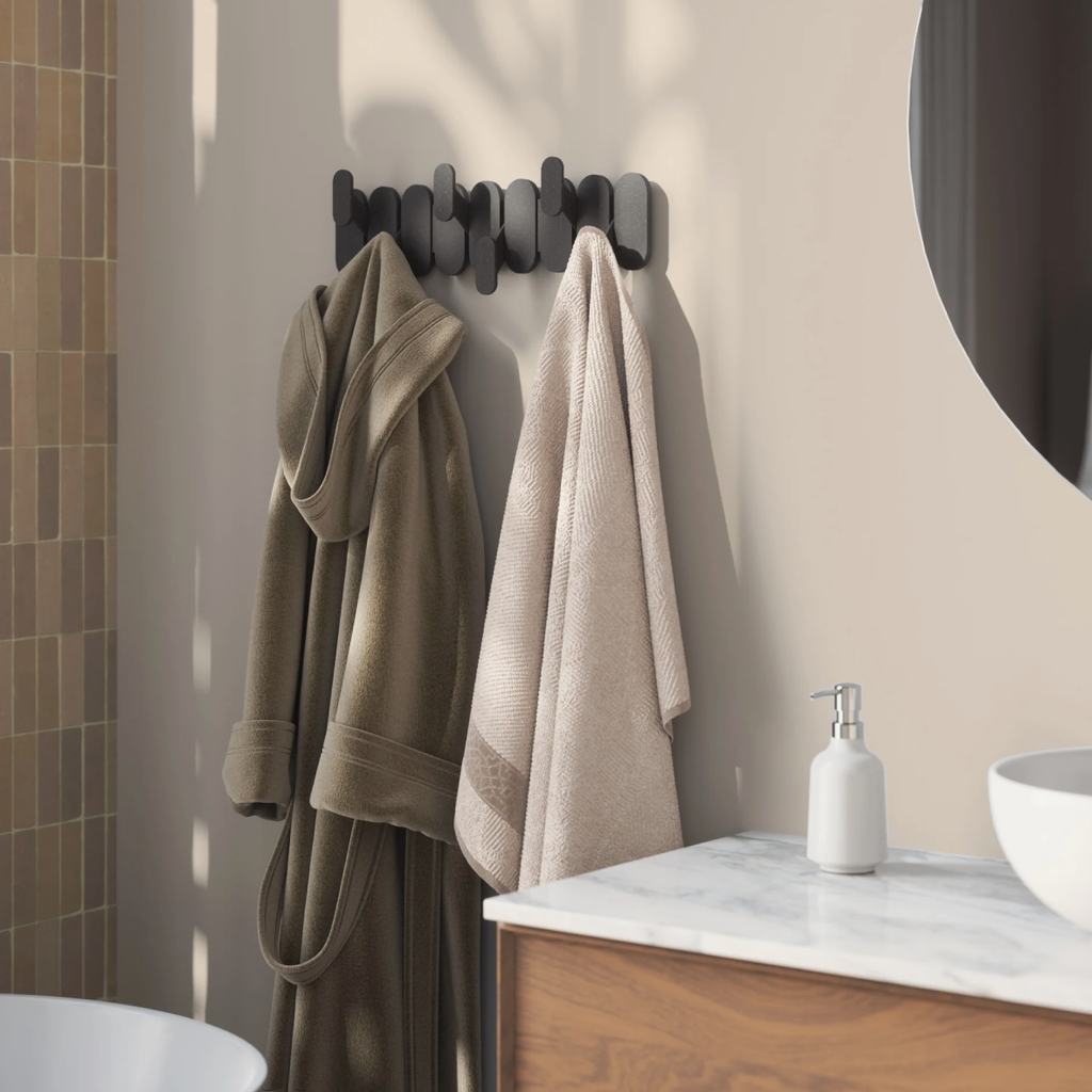 Bathroom scene with towels hanging on a rack and a sink in the background