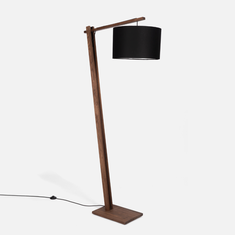 Walnut floor lamp with a black shade on a white background
