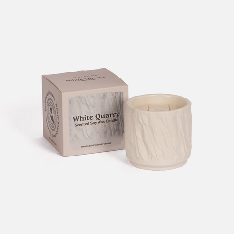 White Quarry scented soy wax candle with packaging on a white background